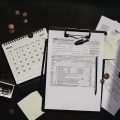 A neatly organized workspace featuring tax forms, calendar, magnifying glass, and office supplies for efficient tax preparation.